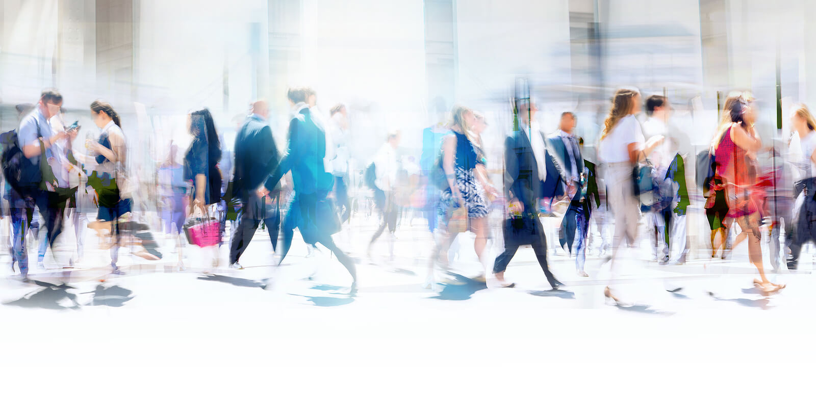 Photo of business people walking in London slightly blurred representing the stress and anxiety that can occur naturally. A counsellor can help business people manage anxiety & perform at top level.
