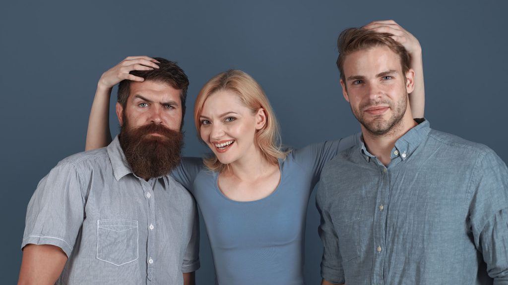 Woman between two men holding their heads in a funny way to take a photo. Making friends as an adult can be tough. Therapy for life transitions, expat therapy and anxiety treatment in the UK can be helpful with a skilled London Counsellor.